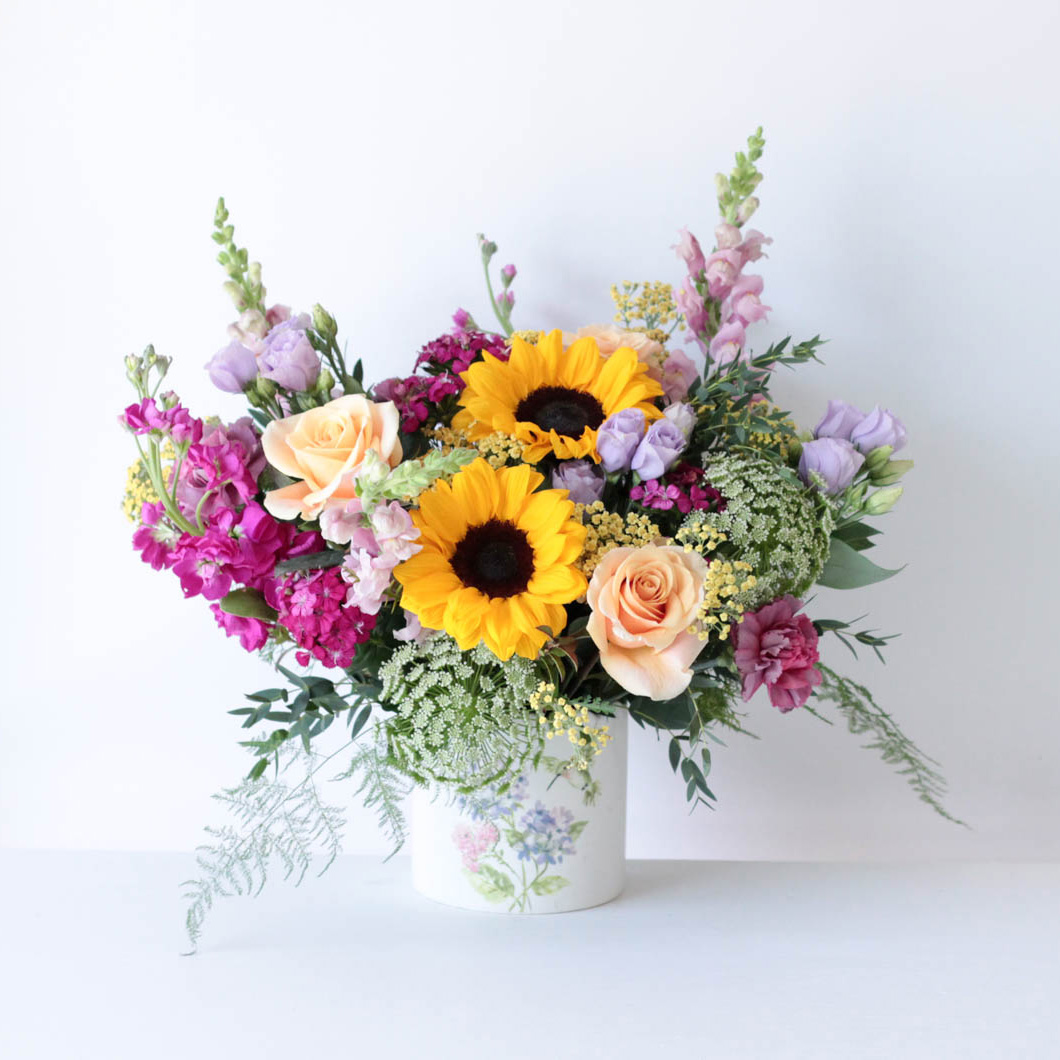 Blanco floral arrangement - featuring a mix of sunflowers, roses, snapdragons, and fragrant stock