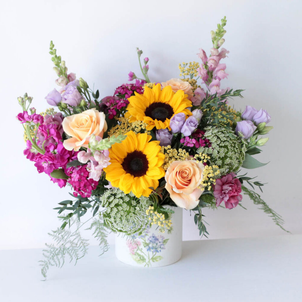 Blanco floral arrangement - featuring a mix of sunflowers, roses, snapdragons, and fragrant stock
